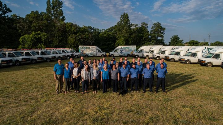 The Lascko Services team in front of their fleet