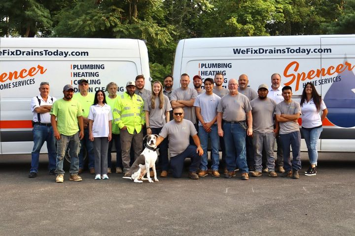 The Spencer Home Services team in front of their vans
